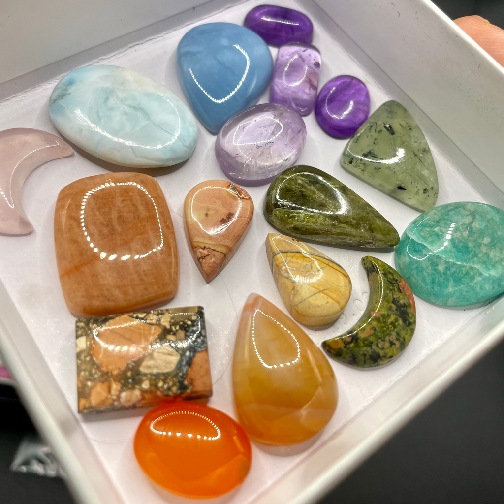 Assorted colorful stones in a white box